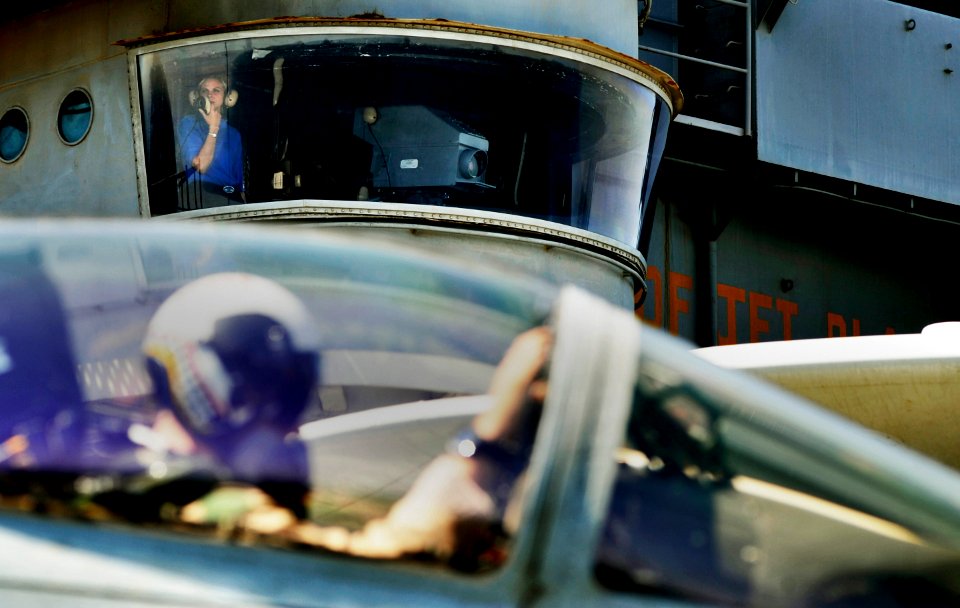 US Navy 100929-N-6003P-163 Aviation Boatswain's Mate (Handling) Airman Audrey Miller surveys aircraft movement from the flight deck camera position