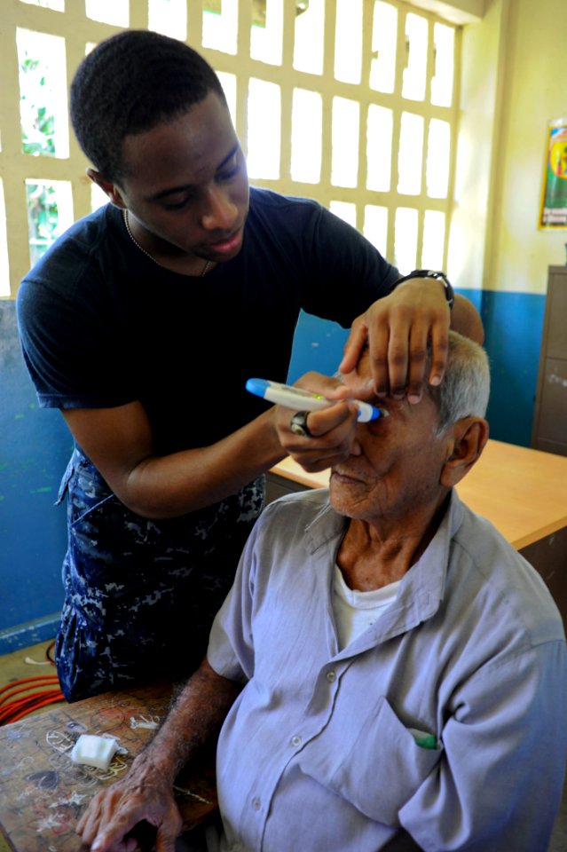 US Navy 100928-N-9964S-090 Hospital Corpsman Aaron London checks a man's eye pressure during a medical screening at a medical site in Panama