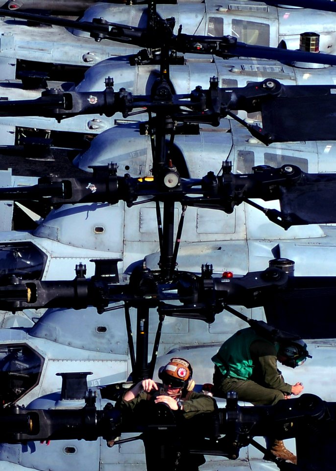 US Navy 100925-N-9950J-095 Lance Cpl. Christopher Horvet, left, assigned to Marine Attack Squadron (VMA) 542, conducts maintenance on the rotor of