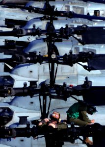 US Navy 100925-N-9950J-095 Lance Cpl. Christopher Horvet, left, assigned to Marine Attack Squadron (VMA) 542, conducts maintenance on the rotor of