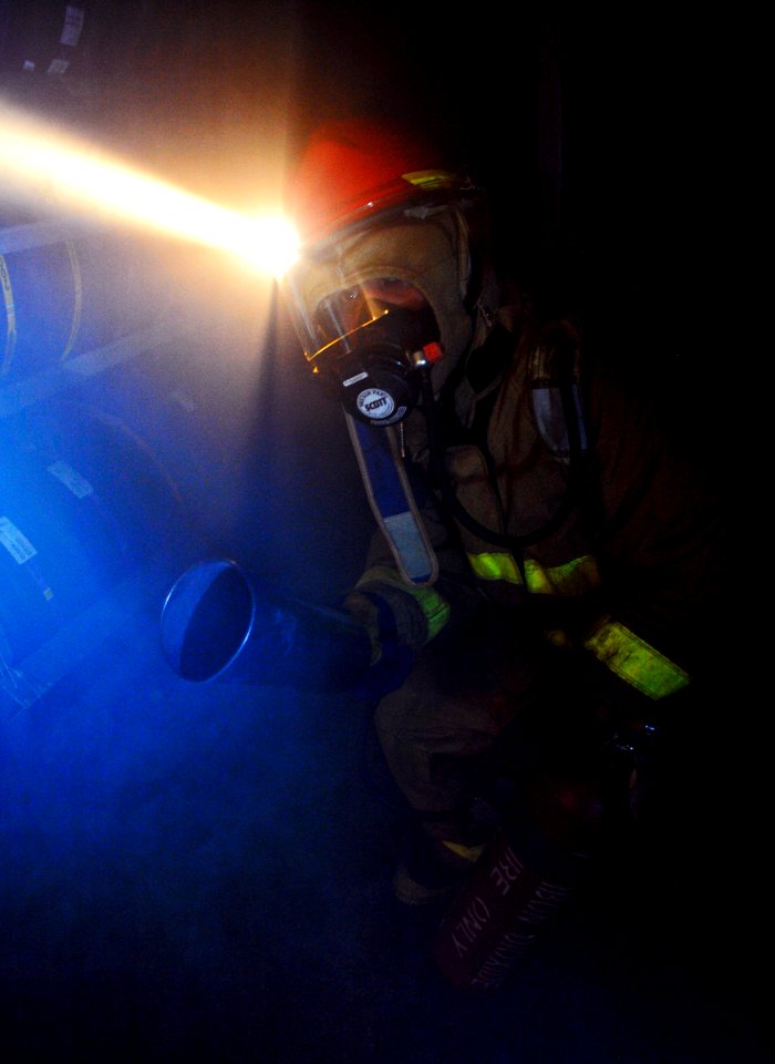 US Navy 100928-N-6003P-663 Personnel Specialist 3rd Class Macallan Diaz prepares to use a CO2 bottle during a general quarters drill aboard USS Har
