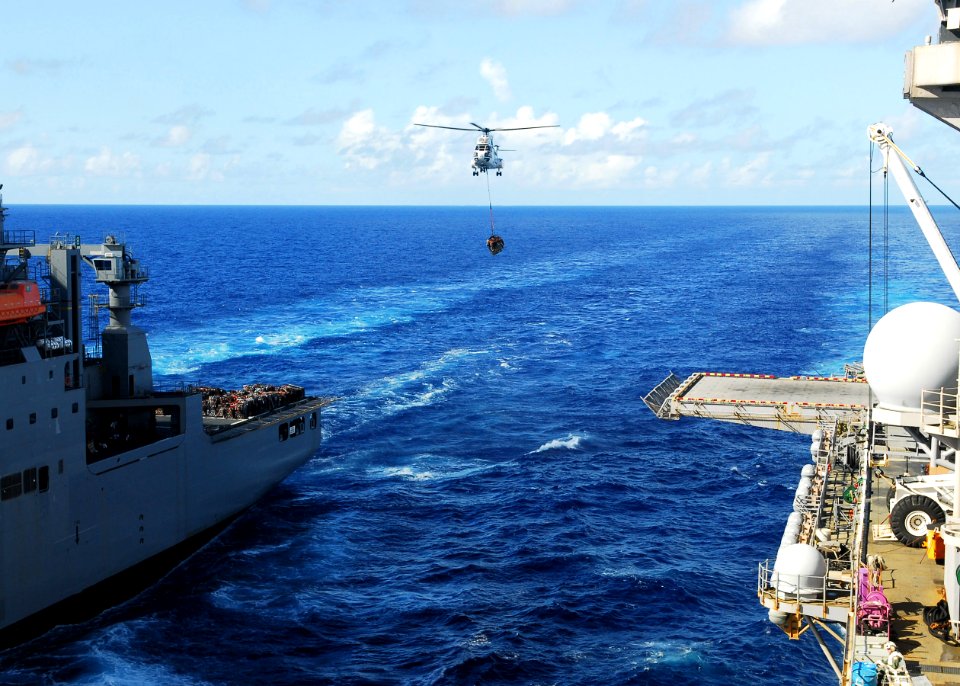 US Navy 101002-N-2218S-029 An AS322 Super Puma helicopter carries supplies from USNS Alan Shepard (T-AKE 3) to USS Essex (LHD 2) during a replenish