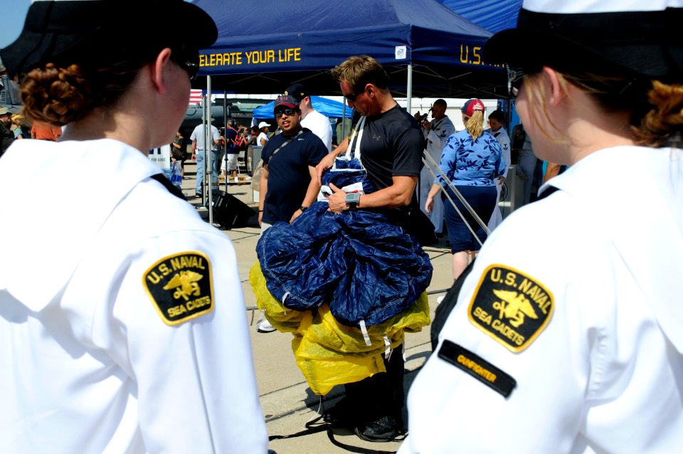 US Navy 101002-N-5366K-129 A chief special warfare boat operator assigned to the Leap Frogs packs his parachute after performing during the opening
