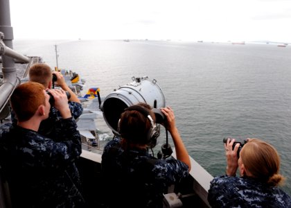 US Navy 101007-N-4973M-058 Sailors stand sighting watch as the aircraft carrier USS Abraham Lincoln (CVN 72) transits the Strait of Malacca photo