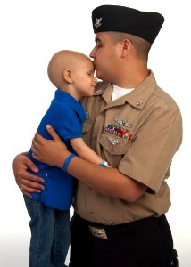 US Navy 101005-N-0000X-001 Personnel Specialist 2nd Class Enrique Ramirez hugs his 4-year-old daughter, Arianna, during a photography session