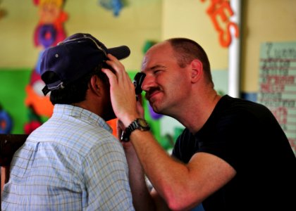 US Navy 101001-N-1531D-195 Lt. Brian Engesser conducts an eye exam during a Continuing Promise 2010 medical community service event photo