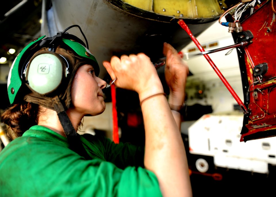 US Navy 101003-N-6427M-079 Aviation Electronics Technician 2nd Class Mandie Ellis emoves a worn out shock mount on a EA-6B Prowler