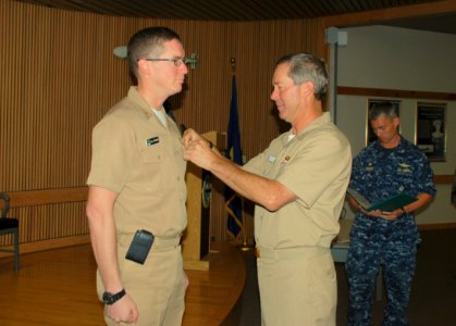 US Navy 101003-N-3241S-100 Rear Adm. Michael McLaughlin, right, pins the Bronze Star Medal on Lt. Cmdr. Colin McGuire in Bledsoe Hall at Navy Subma photo