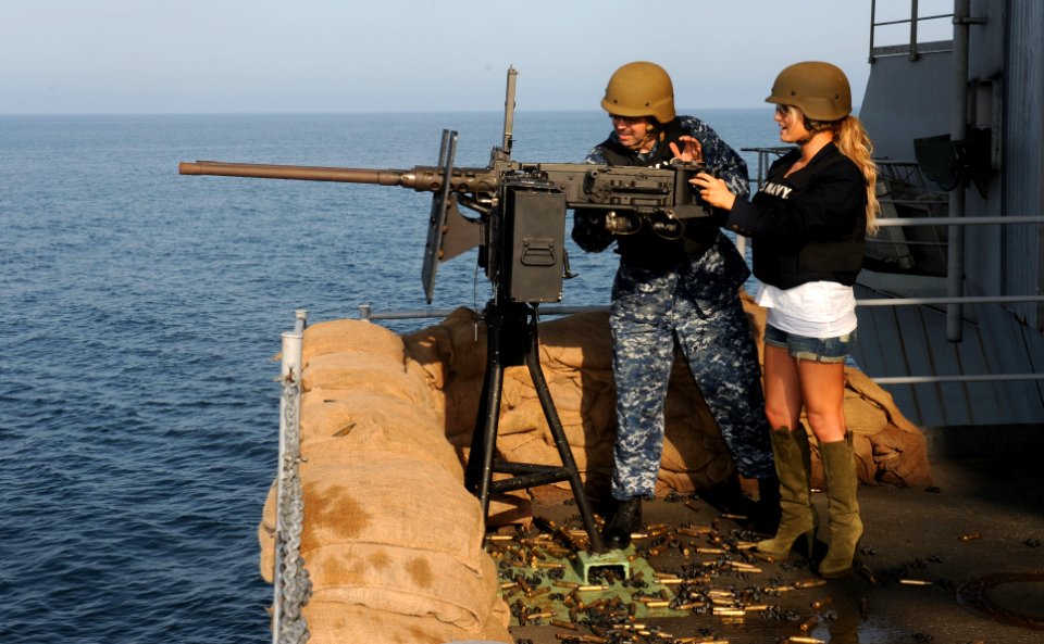 US Navy 101001-N-6362C-046 Chief Gunner's Mate Keith McGinley prepares singer-actress Jessica Simpson for a .50-caliber gun shoot during a USO and