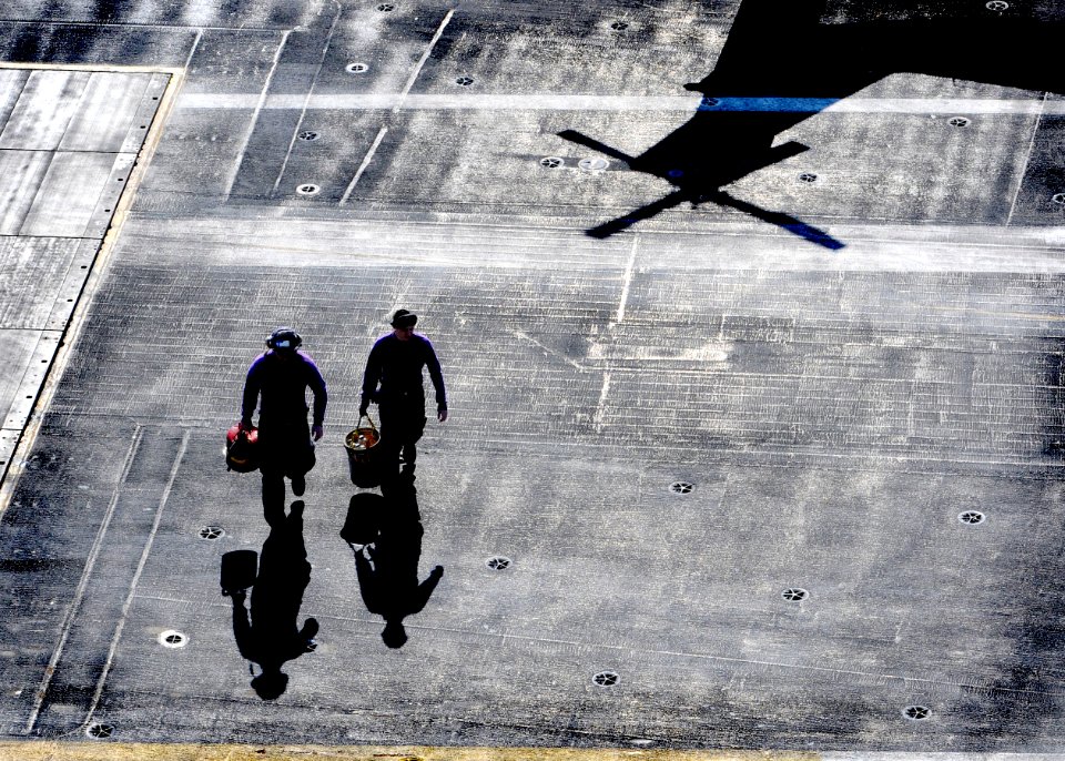 US Navy 101005-N-9589S-004 ailors walk across the flight deck of the aircraft carrier USS Enterprise (CVN 65) after sampling fuel from a helicopter