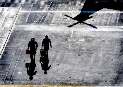 US Navy 101005-N-9589S-004 ailors walk across the flight deck of the aircraft carrier USS Enterprise (CVN 65) after sampling fuel from a helicopter