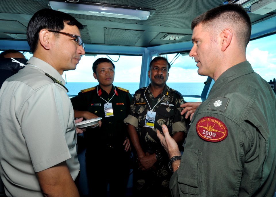 US Navy 101001-N-2013O-034 Cmdr. Thomas Bush, right, speaks to members of the Singaporean, Indian and Vietnamese armed forces during a distinguishe