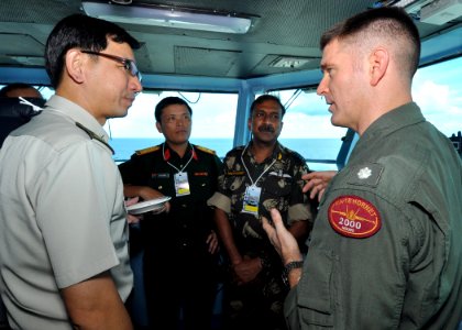 US Navy 101001-N-2013O-034 Cmdr. Thomas Bush, right, speaks to members of the Singaporean, Indian and Vietnamese armed forces during a distinguishe