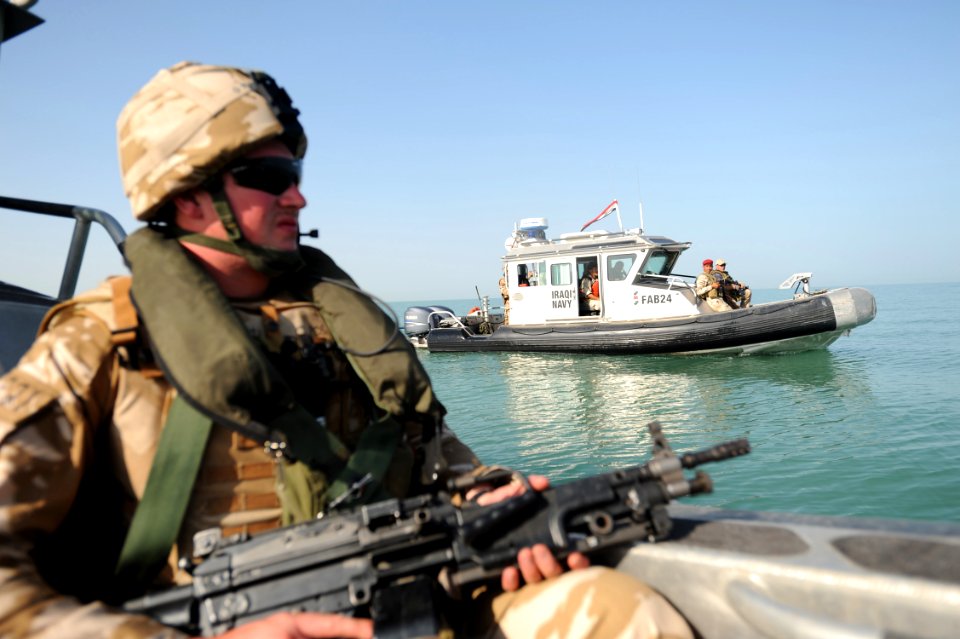 US Navy 101004-N-0413B-113 British Royal Marine, assigned to coalition security forces at Umm Qasr camp, provides security for Iraqi sailors and U
