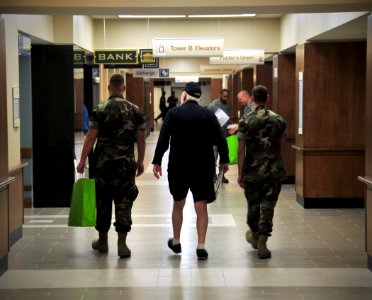 US Navy 101004-N-7367K-005 Service members stationed along the Mississippi Gulf Coast escort military retirees to their living quarters in the refu