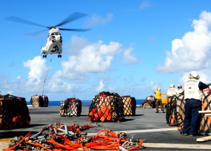 US Navy 101002-N-5538K-055 An AS332 Super Puma helicopter delivers a pallet of supplies onto the flight deck of USS Essex (LHD 2) during a replenis