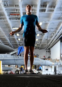 US Navy 101004-N-6427M-149 Airman David Hall, from Buffalo, N.Y., jumps rope during a training session in the hangar bay aboard the aircraft carrie photo