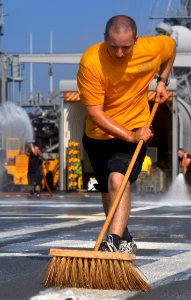 US Navy 101006-N-7293M-358 Aviation Support Equipment Technician 2nd Class Jason Starnes cleans the flight deck of the amphibious transport dock sh