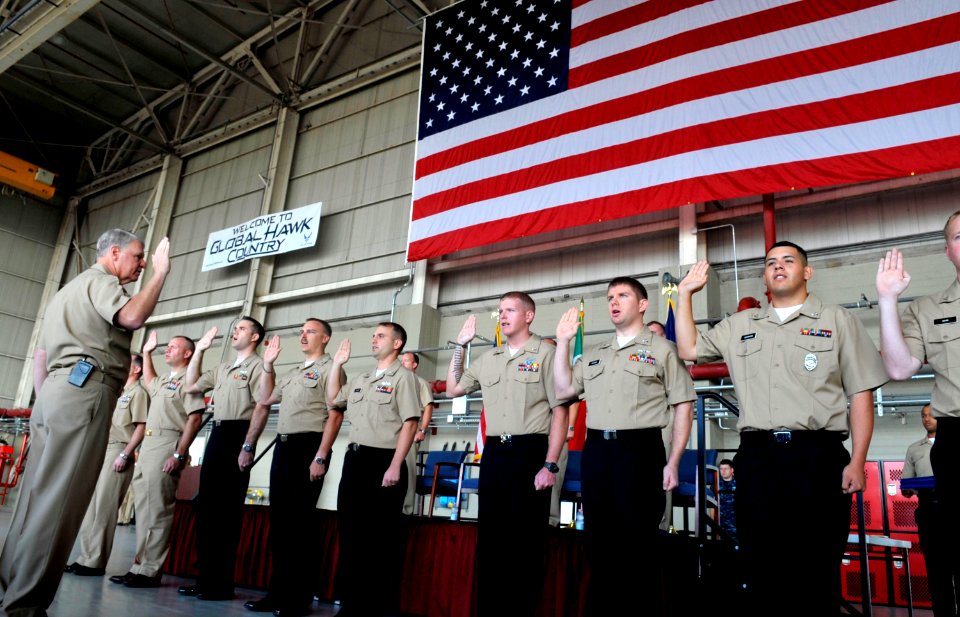 US Navy 101004-N-8273J-065 Chief of Naval Operations (CNO) Adm. Gary Roughead administers the oath of reenlistment to 11 Sailors while visiting Nav