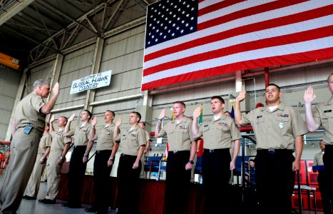 US Navy 101004-N-8273J-065 Chief of Naval Operations (CNO) Adm. Gary Roughead administers the oath of reenlistment to 11 Sailors while visiting Nav photo