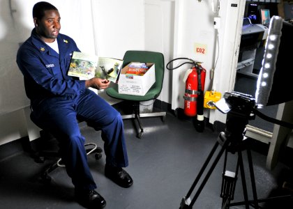 US Navy 101008-N-9950J-019 Cryptologic Technician (Technical) 1st Class Darrick Sanders records a United Through Reading session aboard the forward