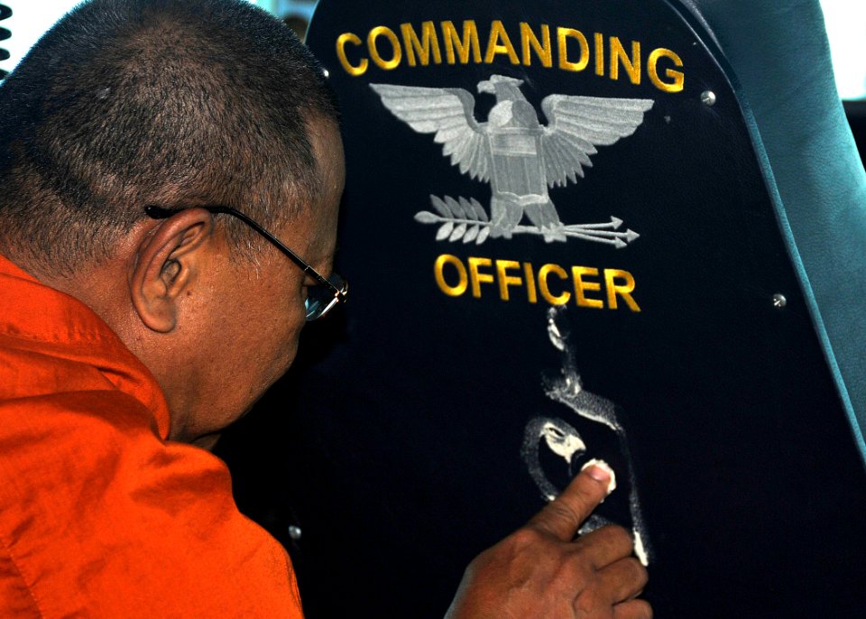 US Navy 101006-N-7103C-094 A Buddhist monk from the Wat Jitapawan Temple blesses Commanding Officer Capt. David A. Lausman's chair during a tour of