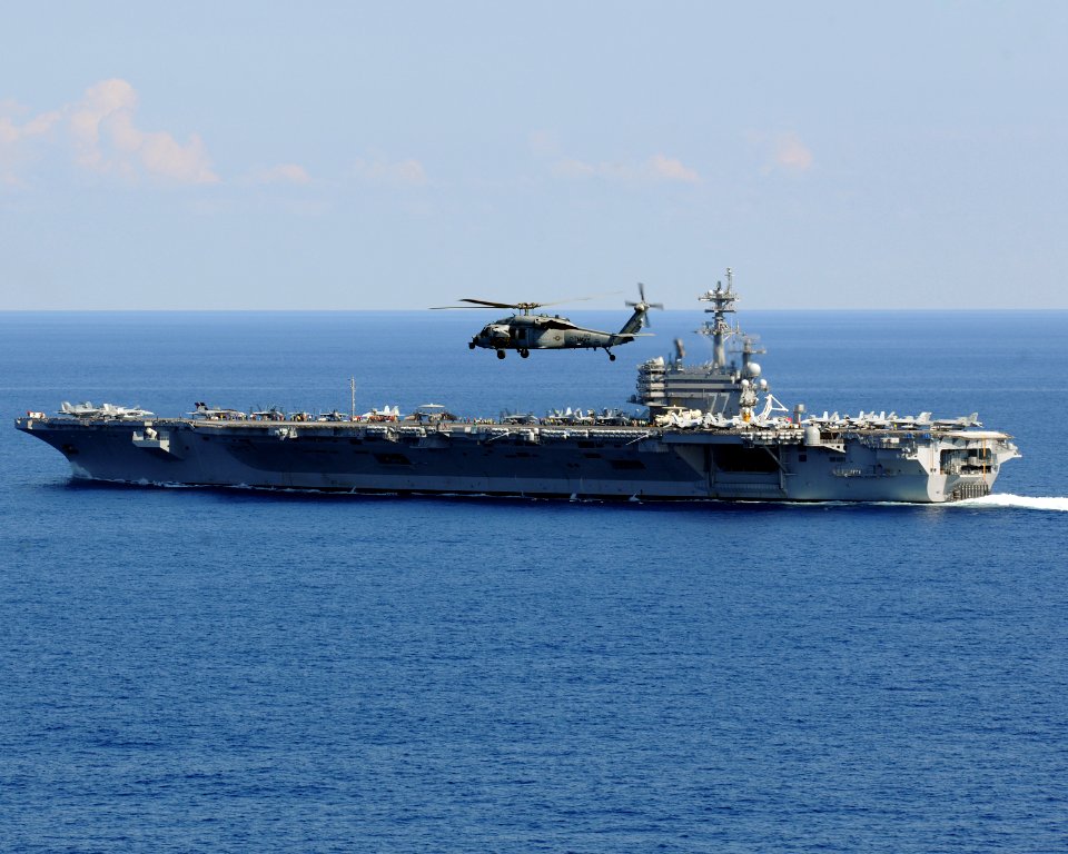 US Navy 101010-N-3885H-426 An MH-60S Seahawk helicopter assigned to Helicopter Sea Combat Squadron (HSC) 9 flies over the aircraft carrier USS Geor