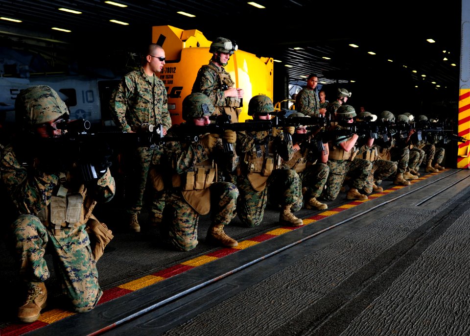 US Navy 101006-N-5538K-130 Marines assigned to the 31st Marine Expeditionary Unit (31st MEU) conduct weapons training in the hangar bay of the forw