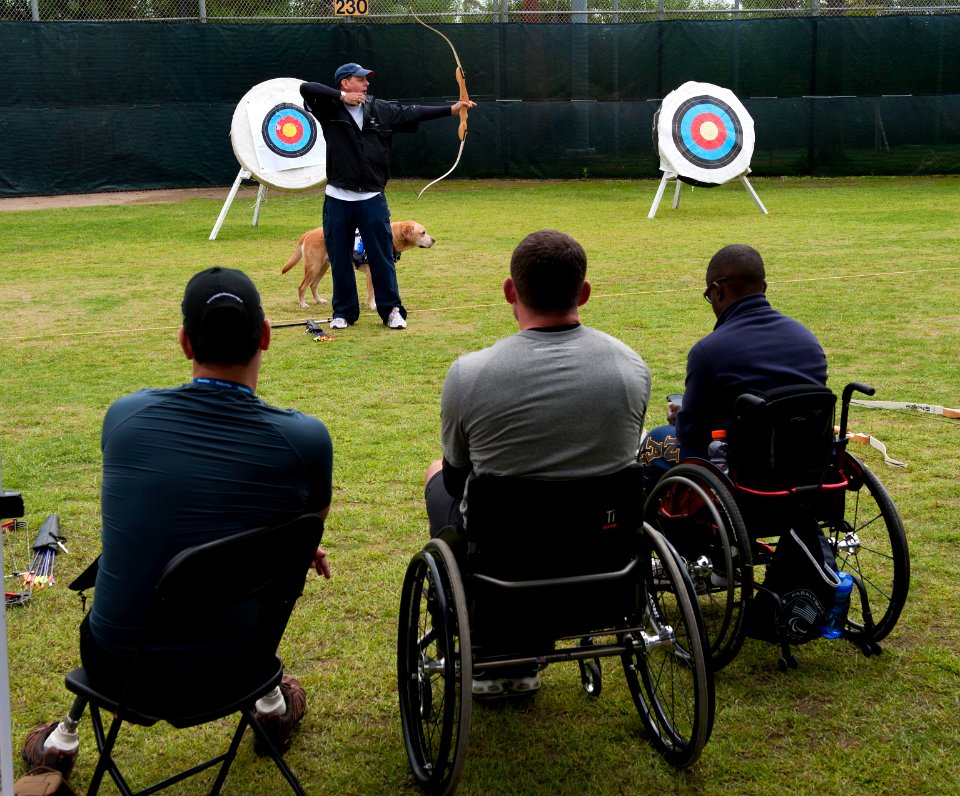 US Navy 101005-N-7981E-610 Retired Army Cpl. Kevin Stone teaches archery techniques to service members during the U.S. Olympic Committee Paralympic