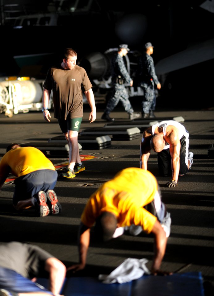 US Navy 101012-N-3793B-244 Nate Owen, the Fit Boss aboard the aircraft carrier USS Harry S. Truman (CVN 75), leads Sailors in a Spartan workout ses