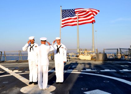 US Navy 101012-N-5292M-790 Sailors conduct morning colors aboard the guided-missile destroyer USS Cole (DDG 67) on the tenth anniversary of the ter