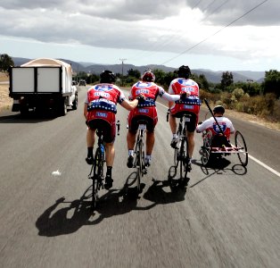 US Navy 101007-N-0288U-002 Cmdr. Bill Crump, left, Maj. Sannon Morelli, John Stevens, and Nate Hunt help each other up a hill during the 450-mile R