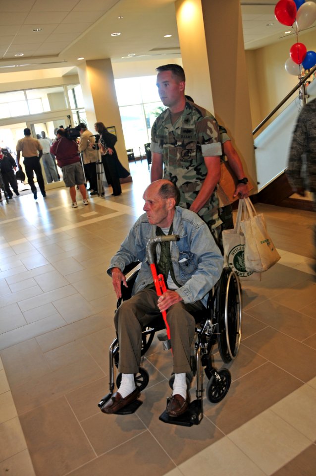 US Navy 101004-N-7367K-004 Equipment Operator 3rd Class Jacob McNamare, assigned to Naval Mobile Construction Battalion (NMCB) 74, escorts retired