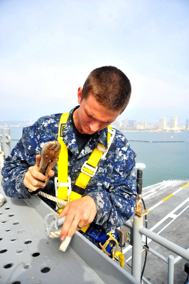 US Navy 101013-N-2953W-692 Seaman Apprentice Justin Crabtree conducts maintenance in the hangar bay of the aircraft carrier USS Carl Vinson (CVN 70