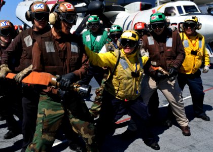 US Navy 101009-N-3374C-048 Sailors prepare to extinguish a fire during a mass casualty drill on the flight deck of the aircraft carrier USS George