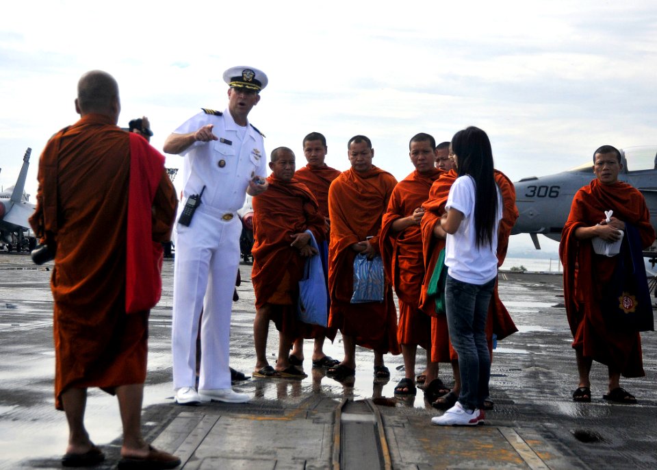 US Navy 101006-N-7103C-060 Cmdr. Pat McClanahan gives Buddhist monks from the Wat Jitapawan Temple a tour of the ship's flight deck