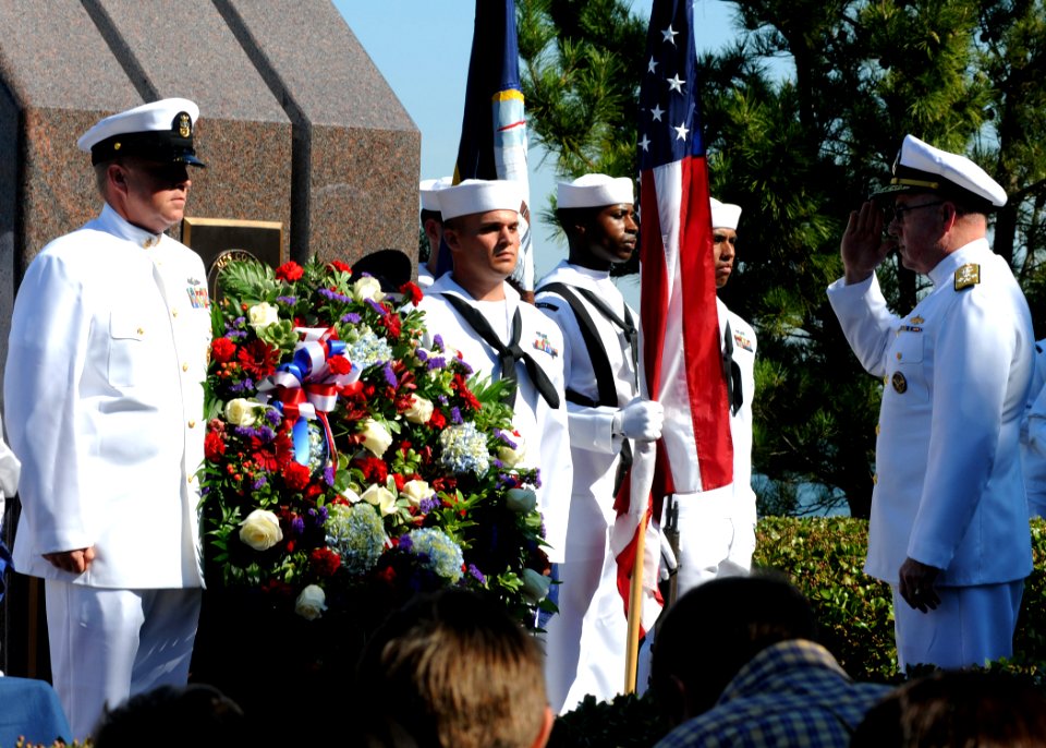 US Navy 101012-N-3737T-144 Adm. J. C. Harvey Jr., right, salutes a wreath at the USS Cole Memorial at Naval Station Norfolk during the 10th anniver