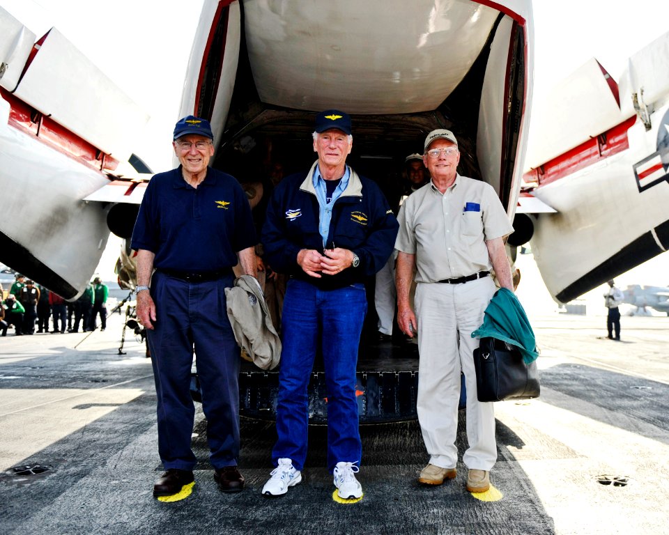 US Navy 101009-N-6003P-082 Retired astronauts Capt. Jim Lovell, Capt. Gene Cernan, and Neil Armstrong stand on painted footprints to commemorate th