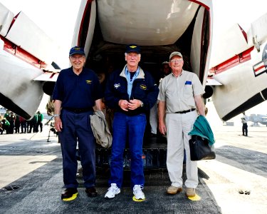 US Navy 101009-N-6003P-082 Retired astronauts Capt. Jim Lovell, Capt. Gene Cernan, and Neil Armstrong stand on painted footprints to commemorate th
