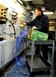 US Navy 101008-N-6362C-014 vionics Technician Airman Matthew Labenz, from Delran, N.J., tests the radar radio frequency test fixture on an F-A-18C