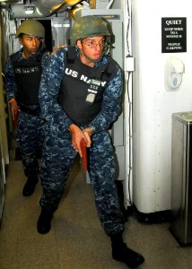 US Navy 101012-N-1004S-044 Operations Specialist 2nd Class Cody Nolin, right, and Logistics Specialist Seaman Gabriel Vasquez breach and clear a be