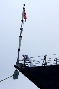 US Navy 101013-N-9643K-940 Sailor assigned to the guided-missile destroyer USS Sampson (DDG 102) performs colors on the morning of the U.S. Navy's
