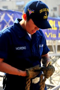 US Navy 101013-N-2953W-899 Aviation Boatswain's Mate (Handling) Airman Heather Moreno secures a grappling hook to a tending line for Sailors perfor