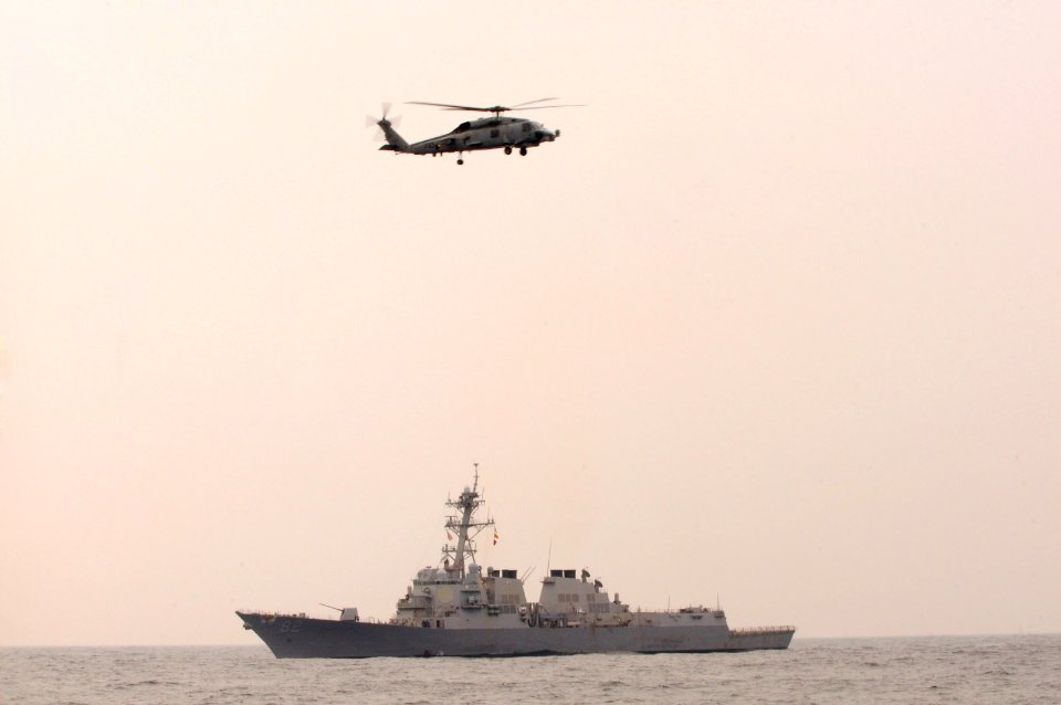 US Navy 101014-N-7478G-205 he guided-missile destroyer USS Lassen (DDG 82) and an SH-60F Seahawk helicopter assigned to Helicopter Anti-submarine S