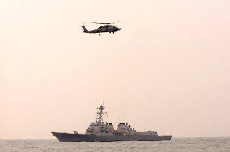 US Navy 101014-N-7478G-205 he guided-missile destroyer USS Lassen (DDG 82) and an SH-60F Seahawk helicopter assigned to Helicopter Anti-submarine S