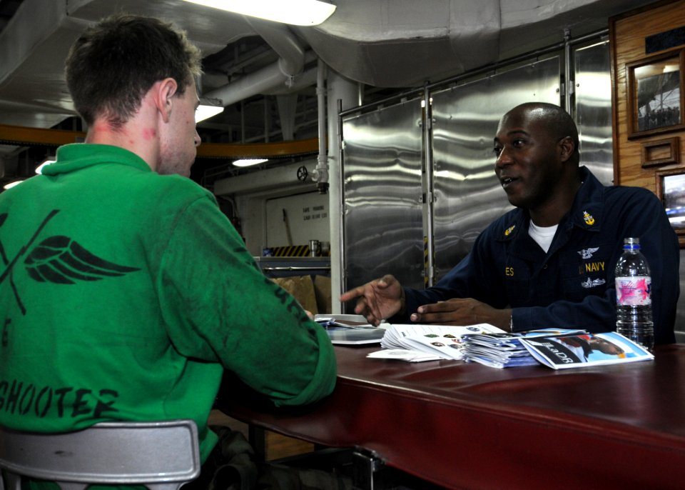 US Navy 101011-N-0754Y-011 Senior Chief Navy Counselor Tyrone Jiles explains the Navy College Program to Aviation Support Equipment Technician 3rd