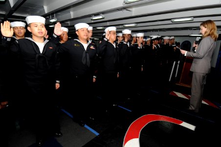 US Navy 101009-N-7191M-072 Sailors take the oath of allegiance during a naturalization ceremony in the foc'sle aboard the aircraft carrier USS Geor