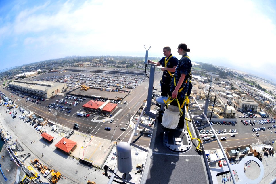 US Navy 101013-N-2953W-443 Electronics Technicians 3rd Class Sean Kilcoyne and Laura Colliton conduct maintenance on the main mast of the aircraft