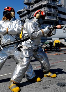 US Navy 101009-N-3374C-022 Sailors man the fire hoses during a mass casualty drill on the flight deck of the aircraft carrier USS George H.W. Bush