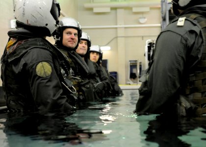 US Navy 101013-N-5787K-051 Students at Aviation Survival Training Center prepare to submerge themselves in full gear to simulate worst-case scenar